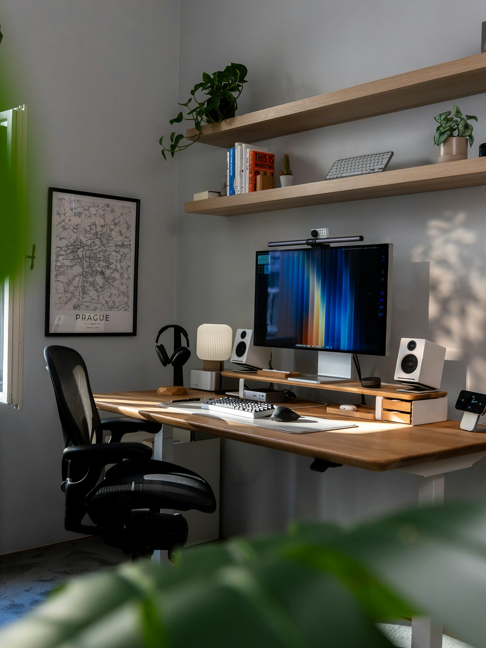 Bright, plant-filled modern desk setup with a computer monitor, representing an email and social strategy workspace