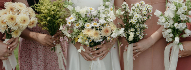 Bridesmaids holding pastel floral bouquets before a spring wedding ceremony