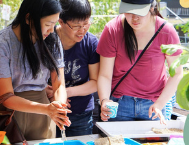 Volunteers assembling supplies at an Embark Sustainability Society community table
